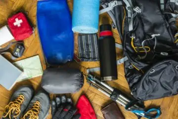 backpacking gear laid out on the floor