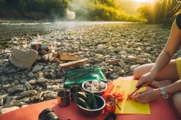 preparing food at a campfire