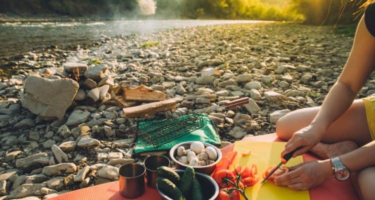 preparing food at a campfire