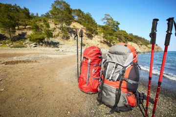 backpacks & hiking poles on the beach