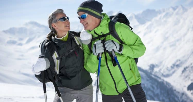 Older couple hiking in the snow