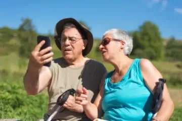 man and woman looking at a phone